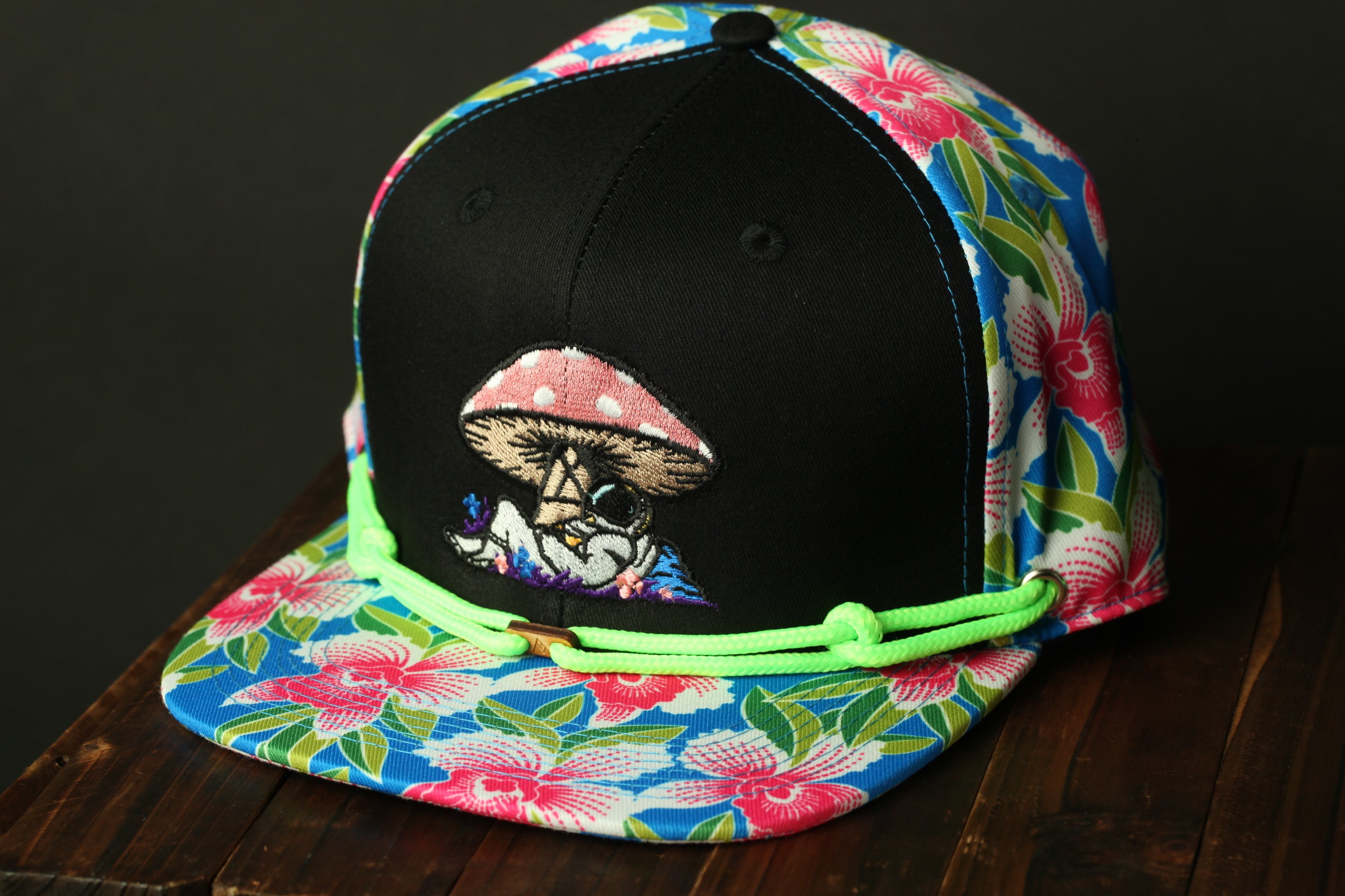 A colorful floral baseball cap with a mushroom design on the front.