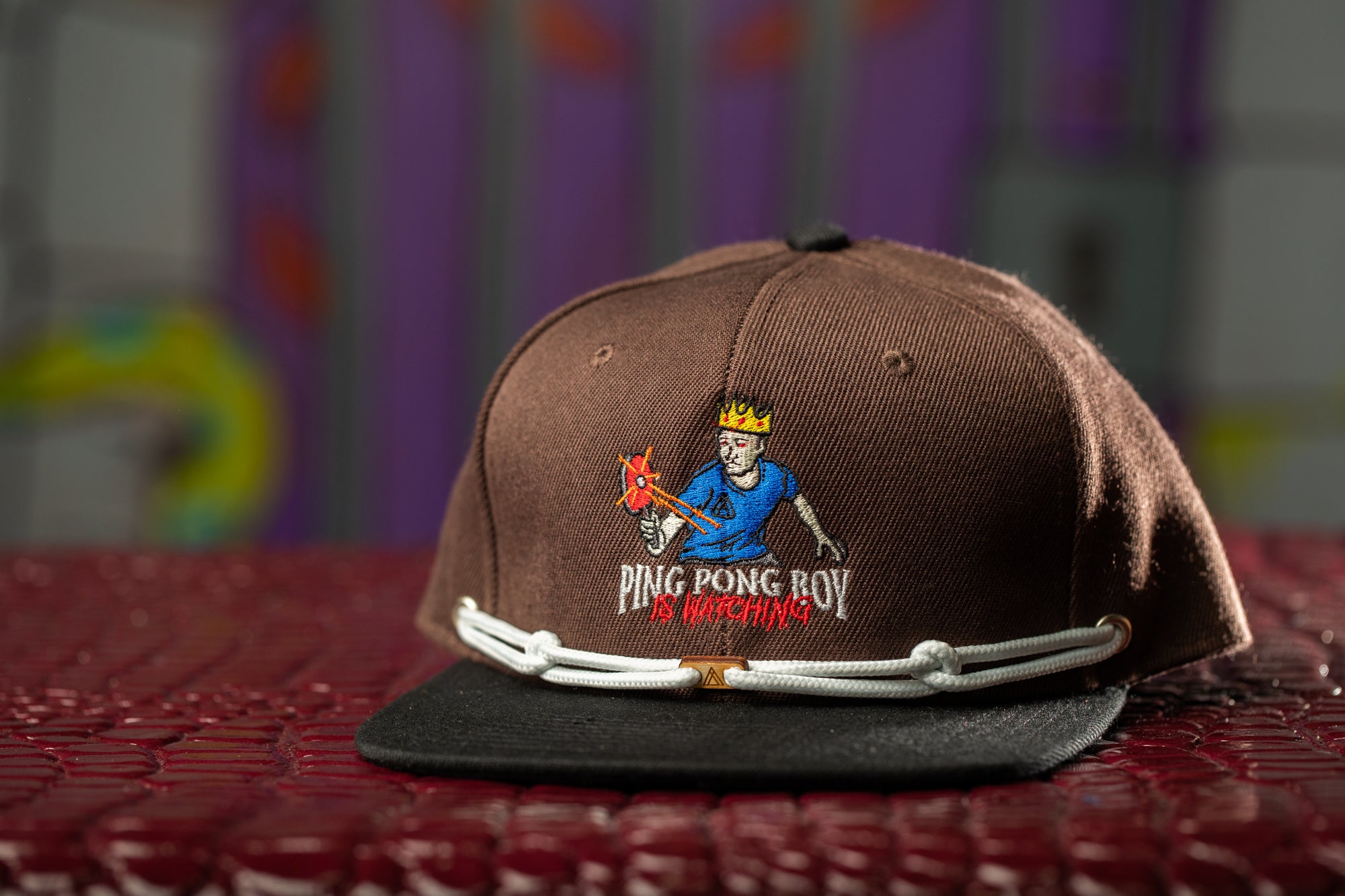 a brown and black hat with a picture of a man on it