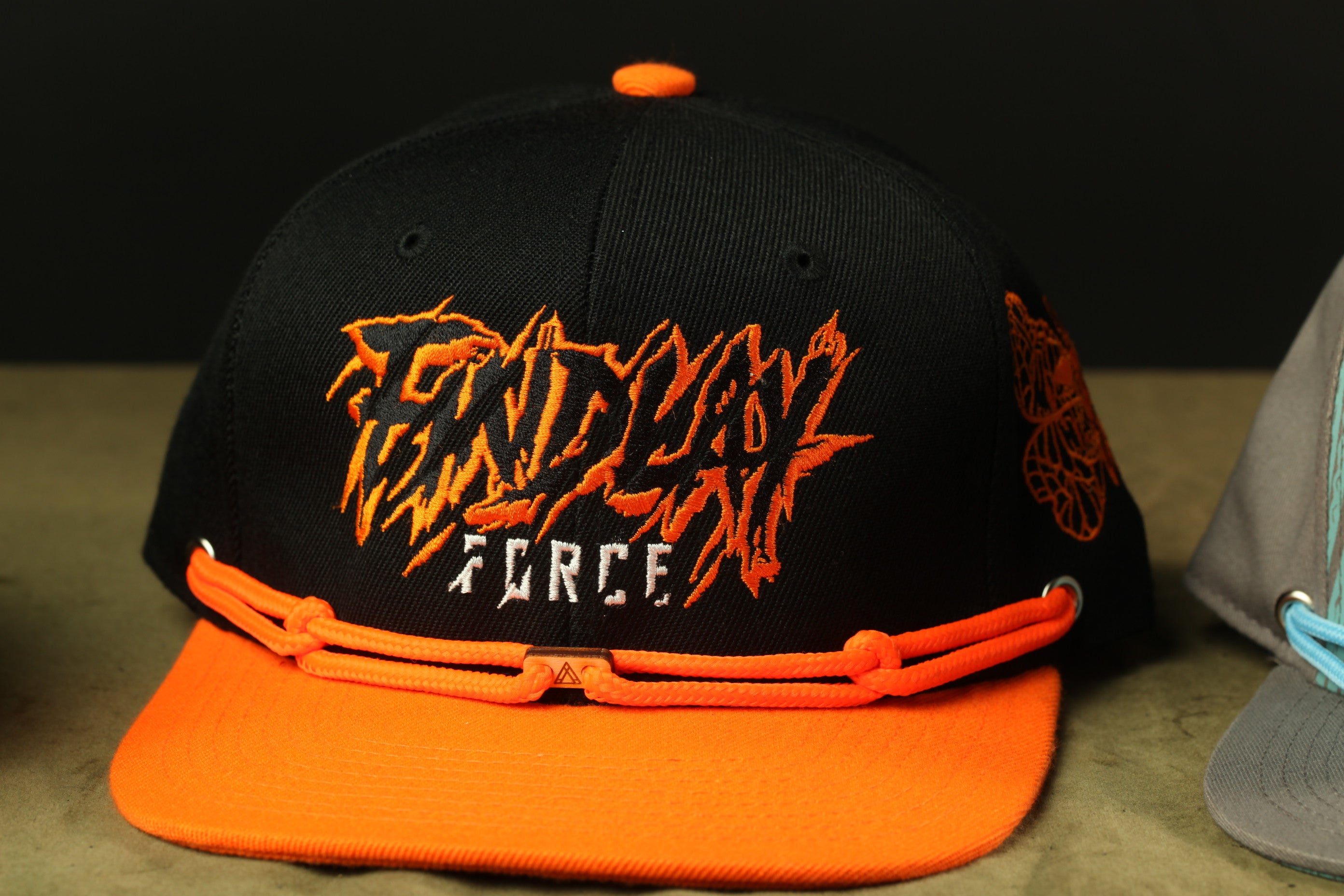A black baseball cap with orange accents, featuring the text "ENDY FORCE" in a stylized font.