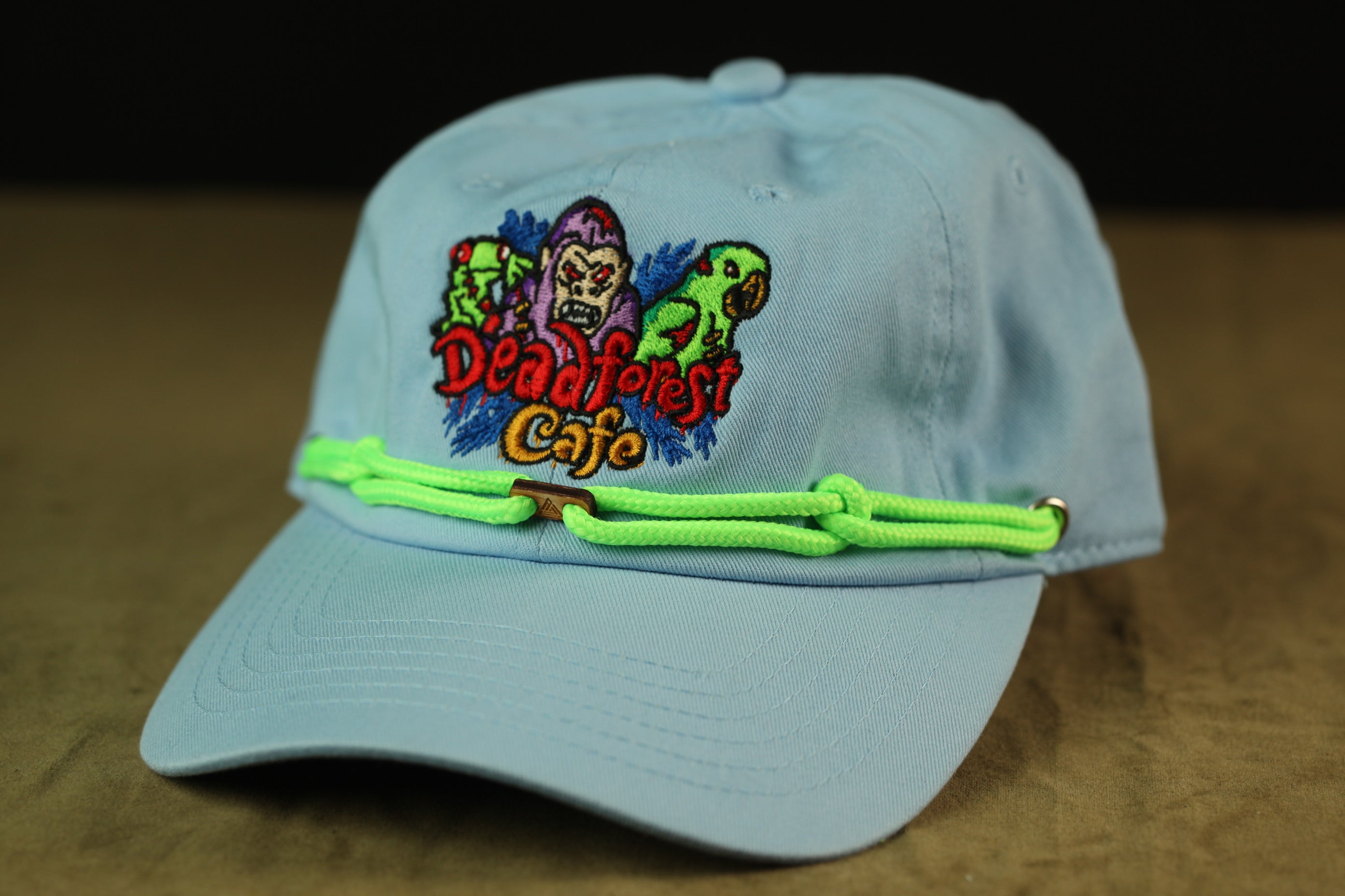 A light blue baseball cap with a colorful embroidered logo on the front.