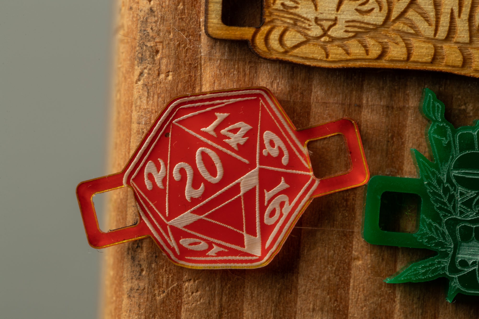 a red dice with the numbers "20" and "16" printed on it, placed on a wooden surface.