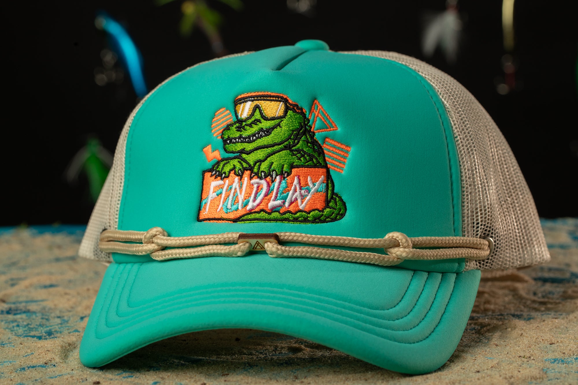 a green hat with a picture of a crocodile on it