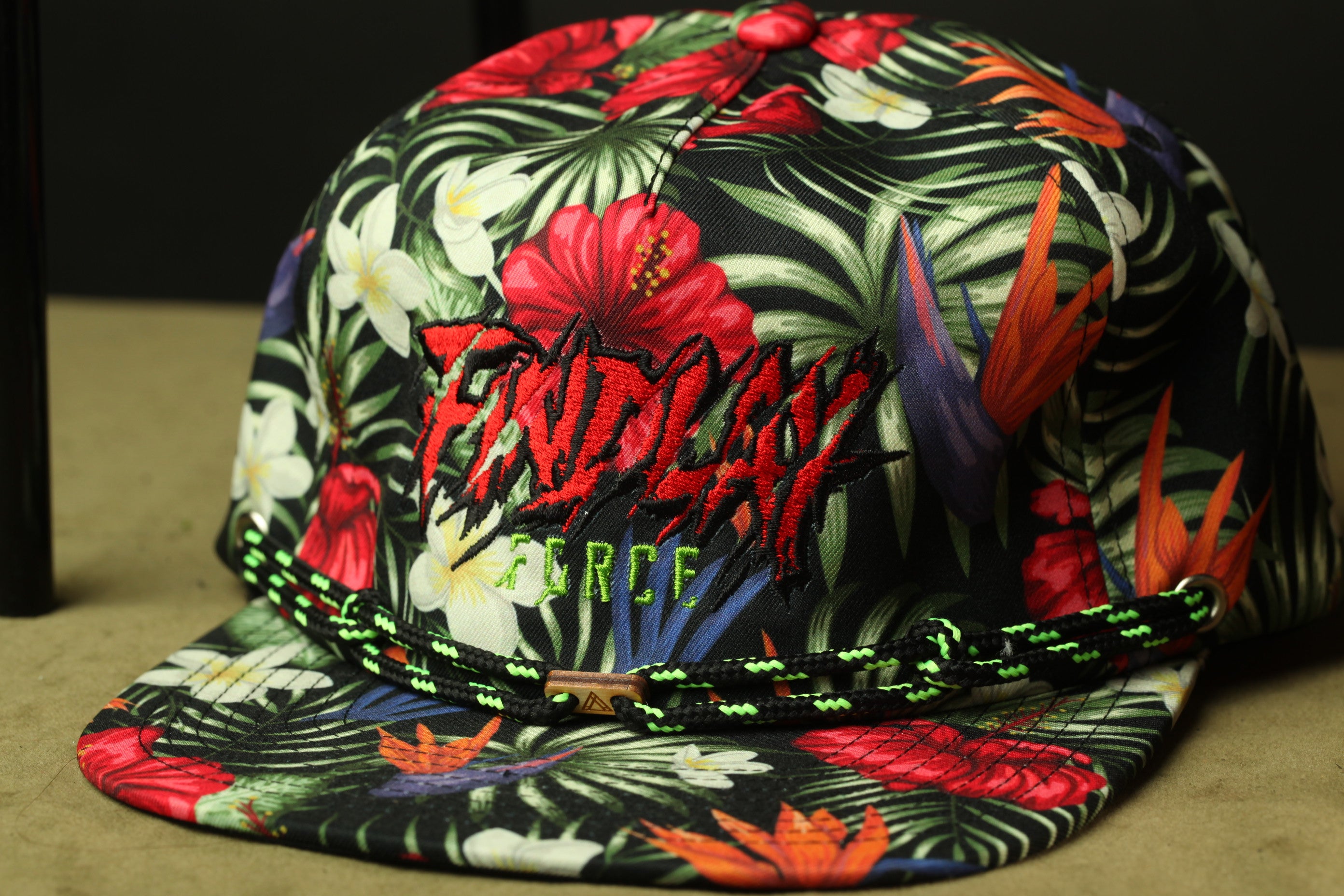 A colorful floral print baseball cap with the word "FRIDAY" printed on it.