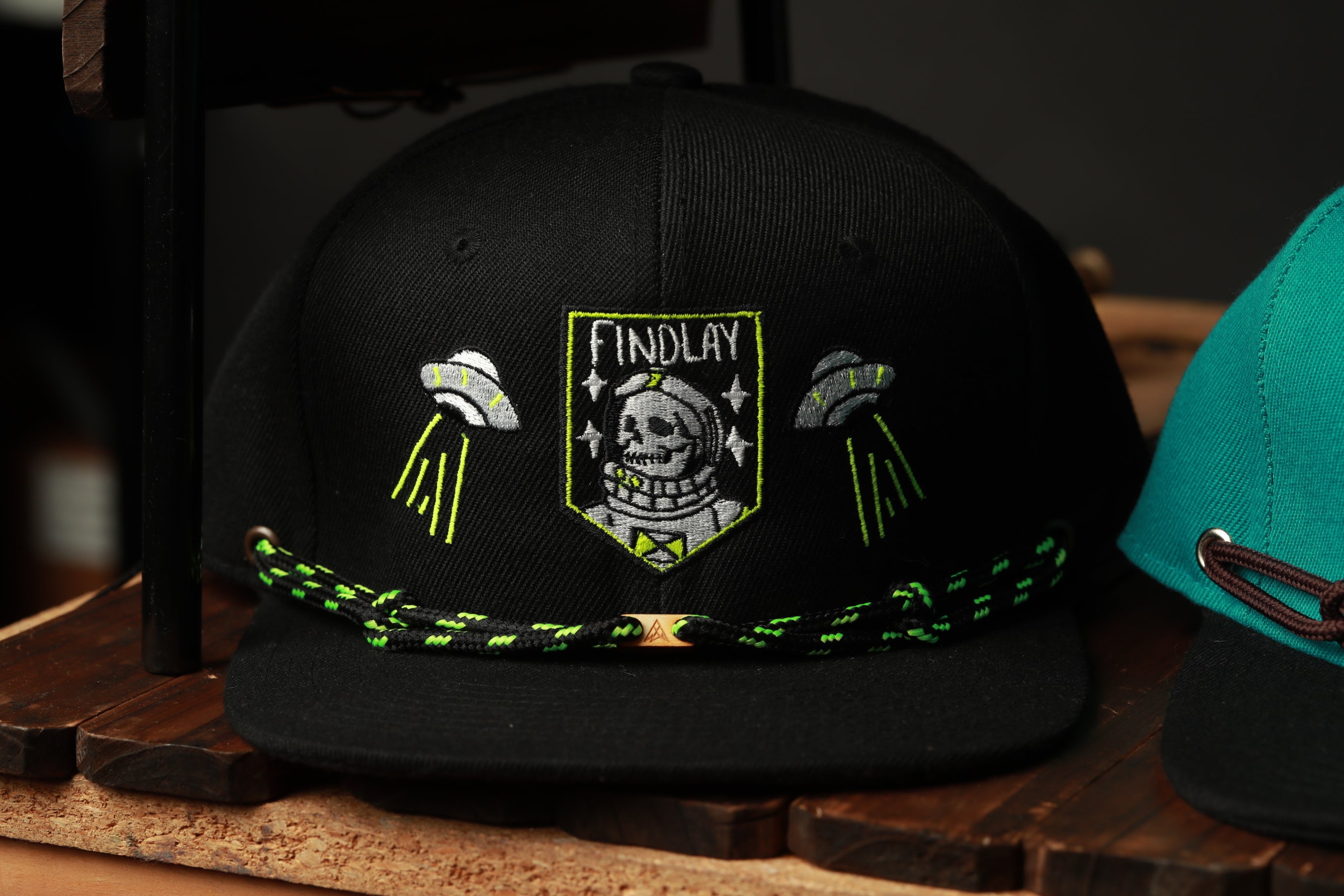 A black baseball cap with a skull and alien motif, featuring the text "FINDLAY" on the front.