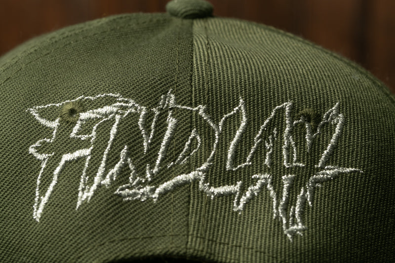 A close-up view of a green baseball cap with the word "FRIDAY" embroidered on it.