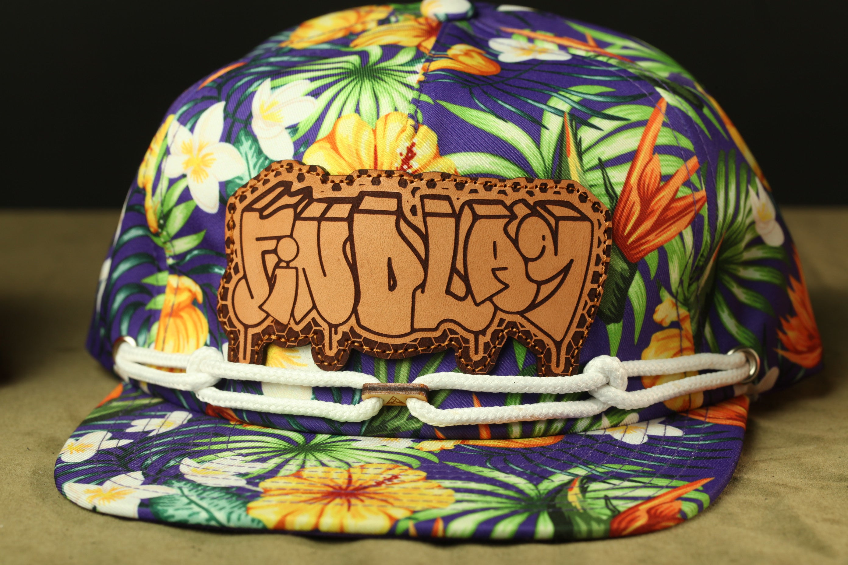 A colorful, patterned baseball cap with a tropical print design.