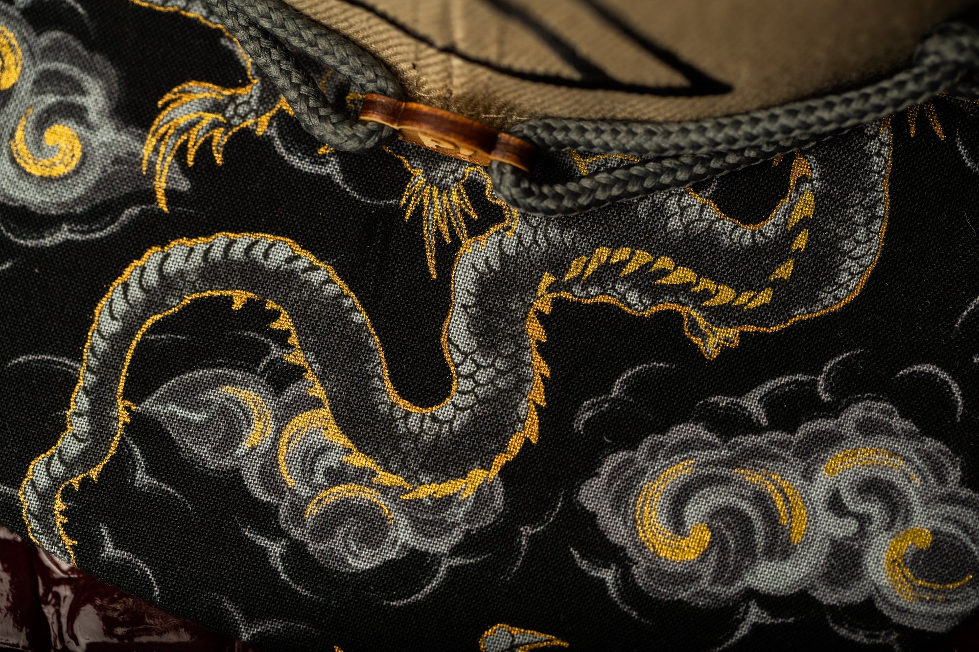 a close up of a bag with a dragon on it
