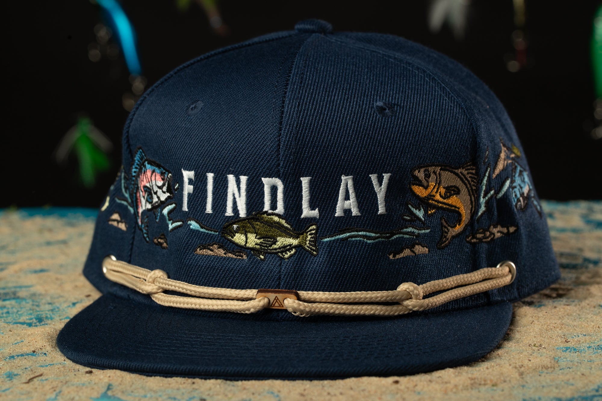 a baseball cap with a fishing scene on it