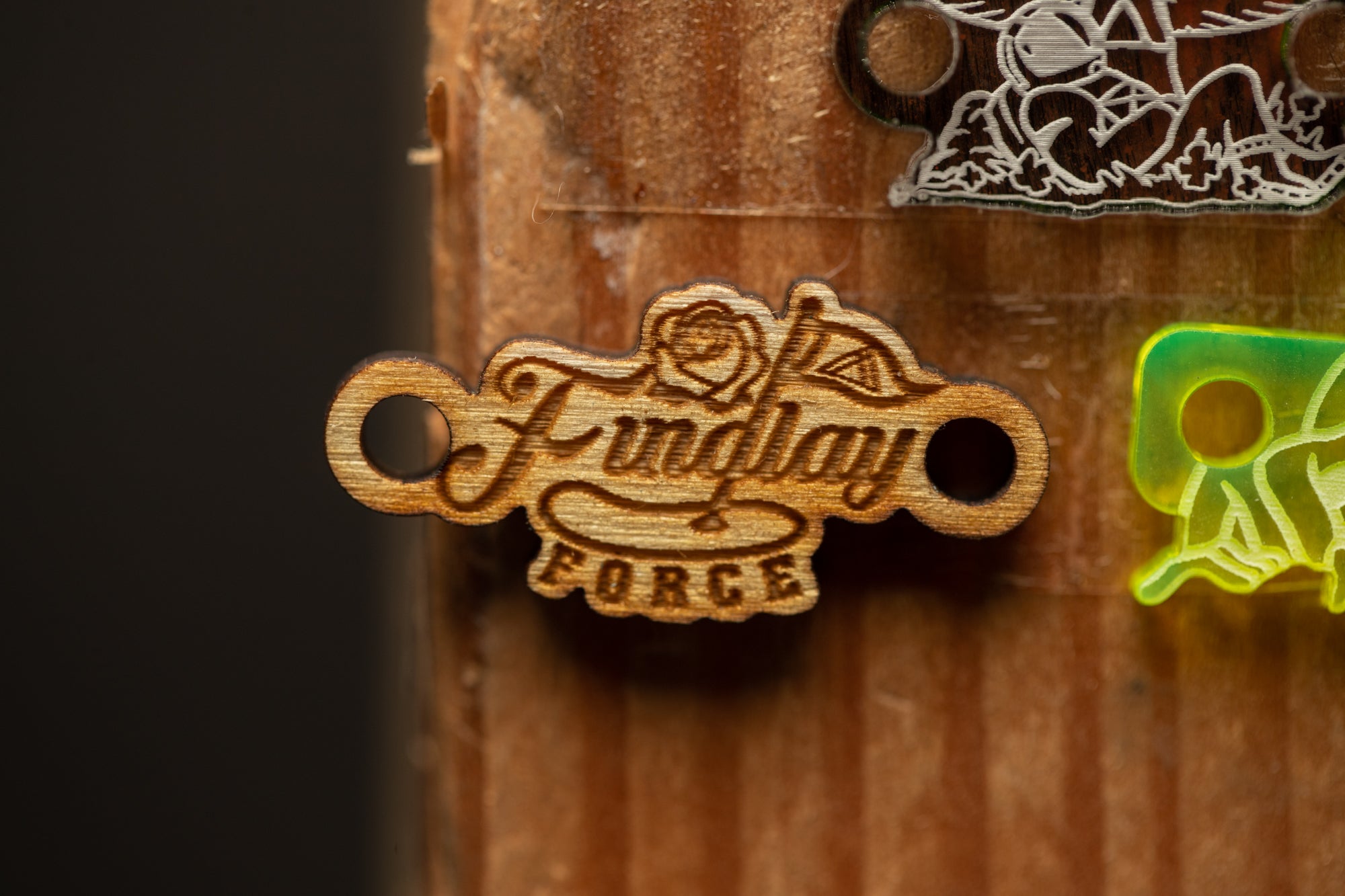 a couple of wooden key chains hanging from a wooden door