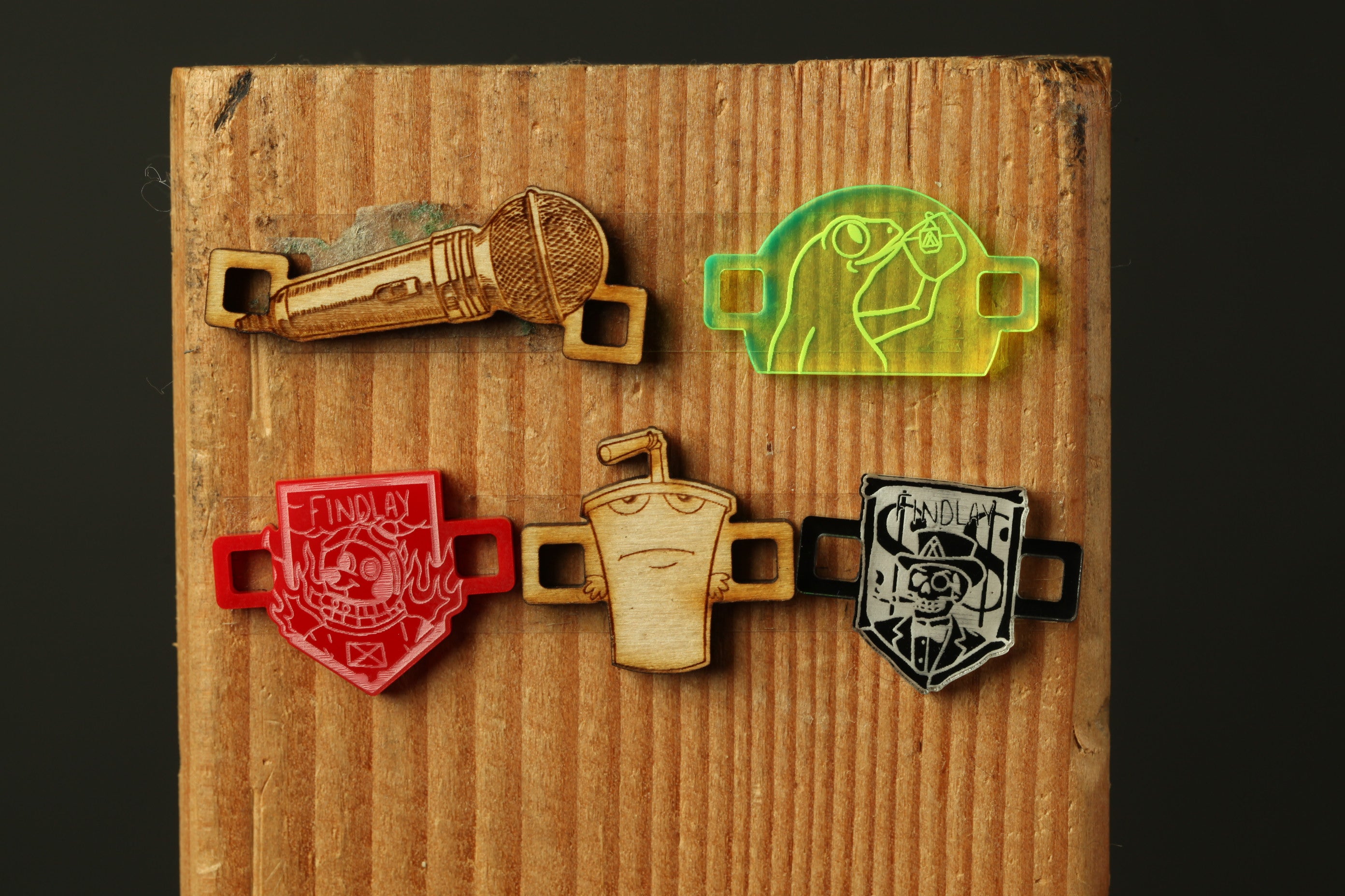 a wooden board with various colorful and unique stickers or decals attached to it.