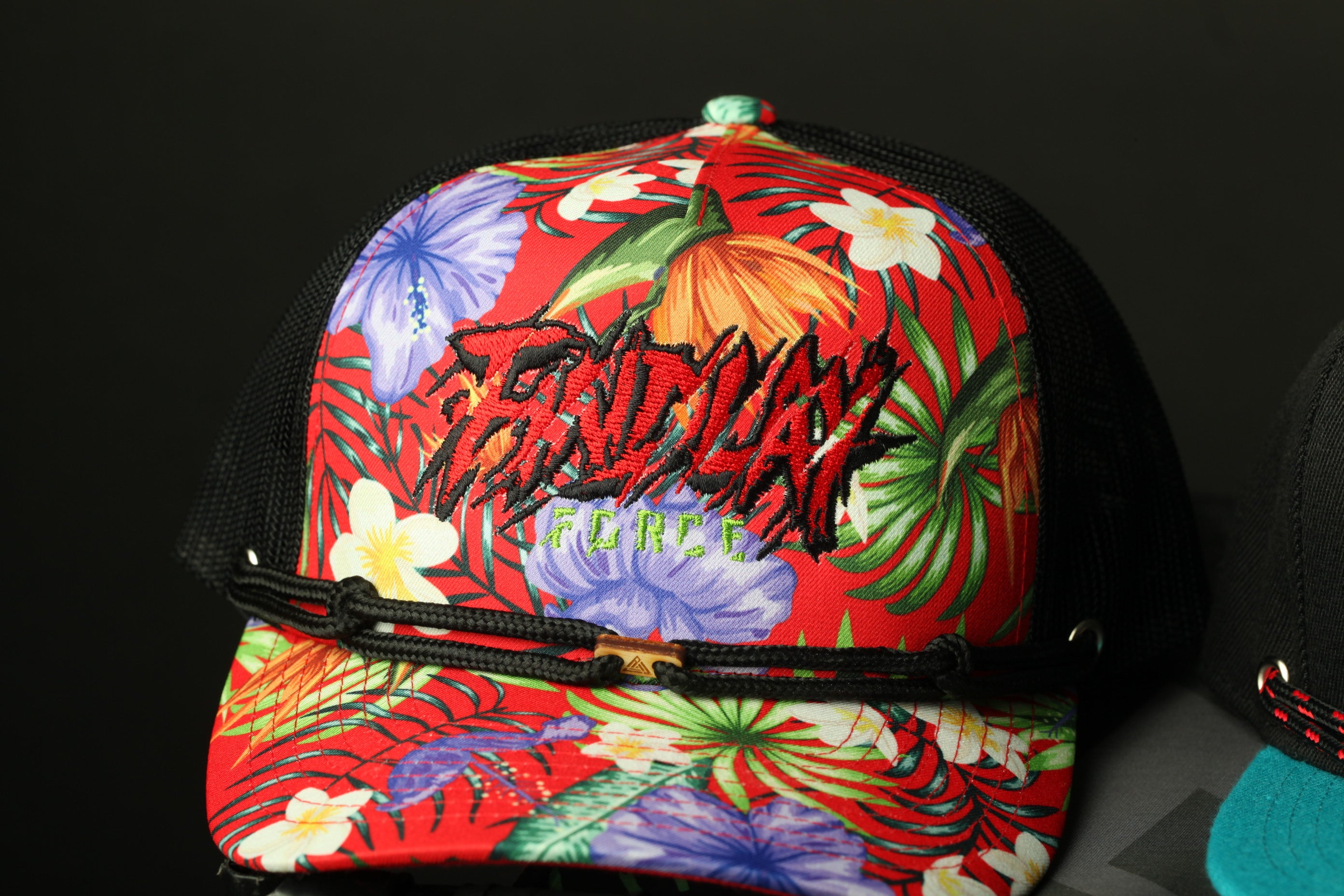 A colorful floral-patterned baseball cap with the word "FRIDAY" printed on it.