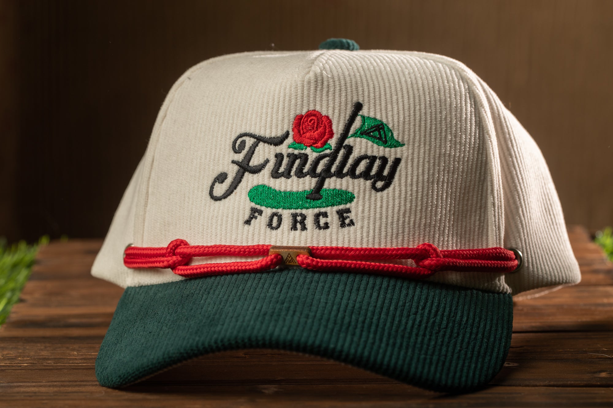 A white baseball cap with a green brim and red string, featuring a logo that says "Funlay Force".