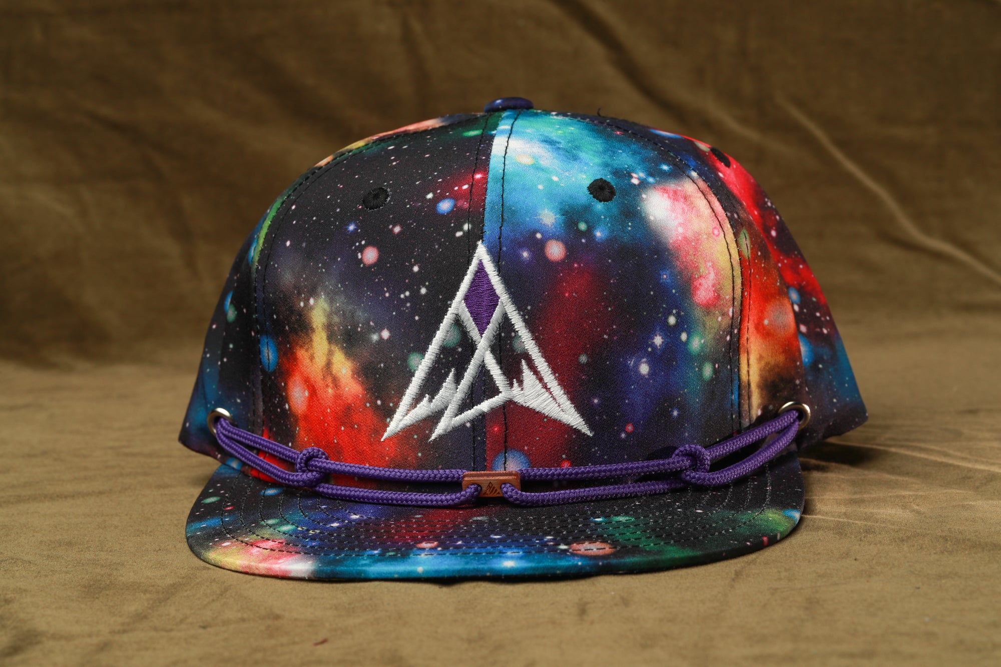 A colorful, patterned baseball cap with a starry galaxy design.