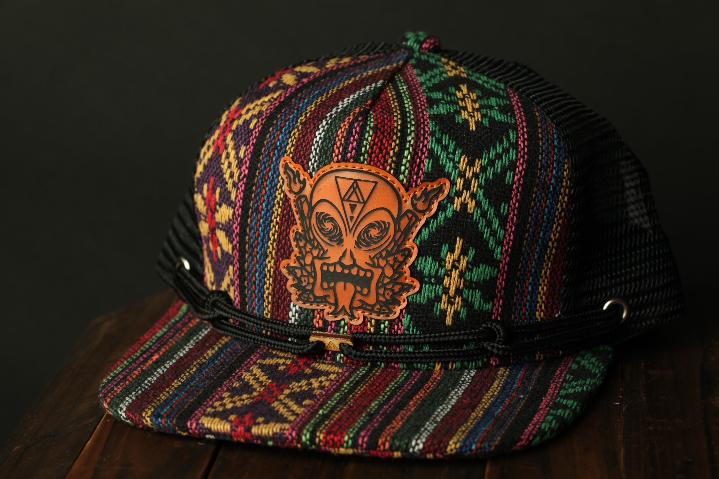 A colorful, patterned baseball cap with a unique design on the front.