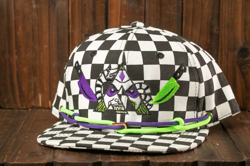 A black and white baseball cap with a checkered pattern and a skull design on the front.
