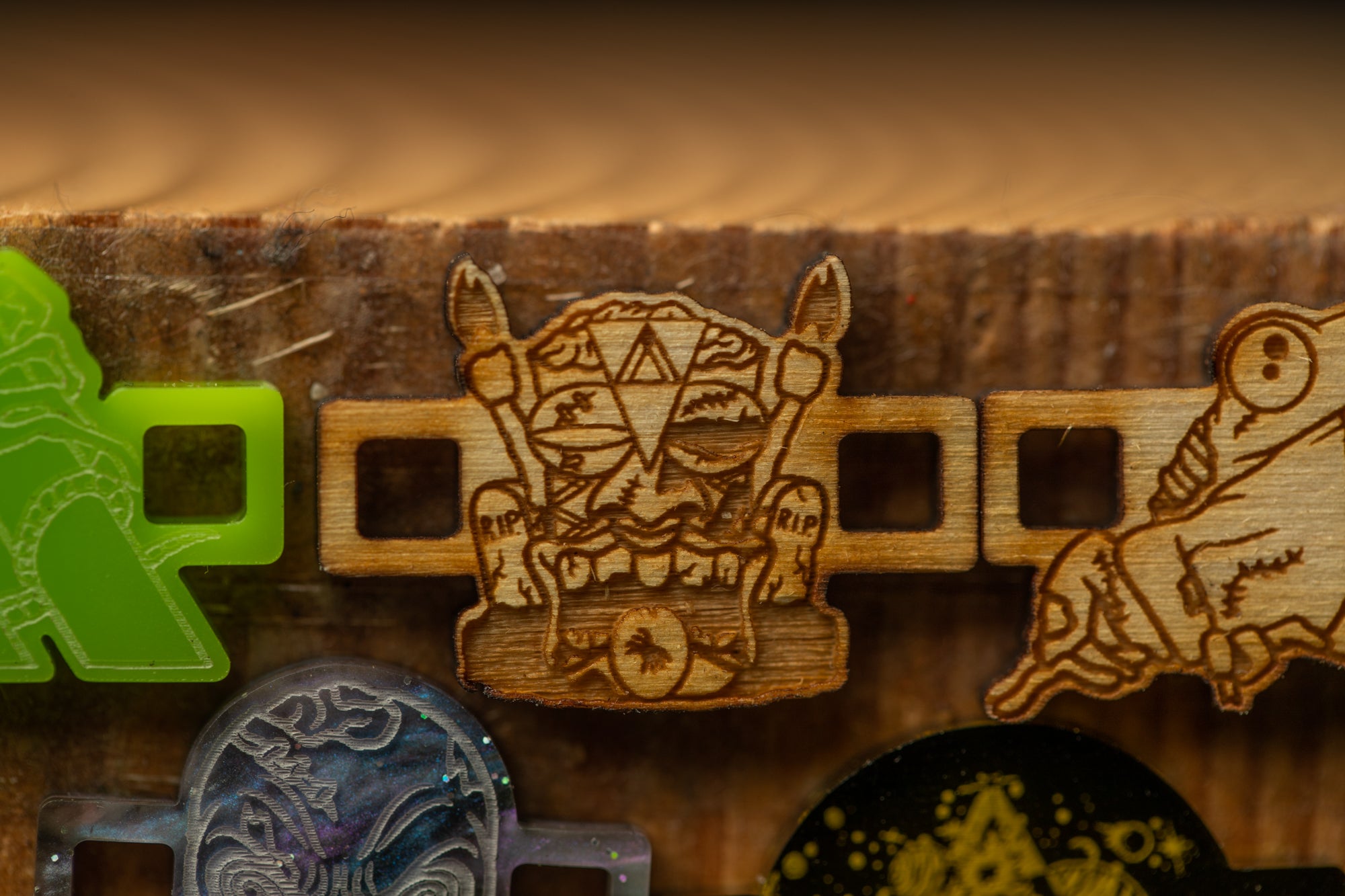 a wooden object with a carved design, including a face and a skull, as well as other wooden objects with various designs.