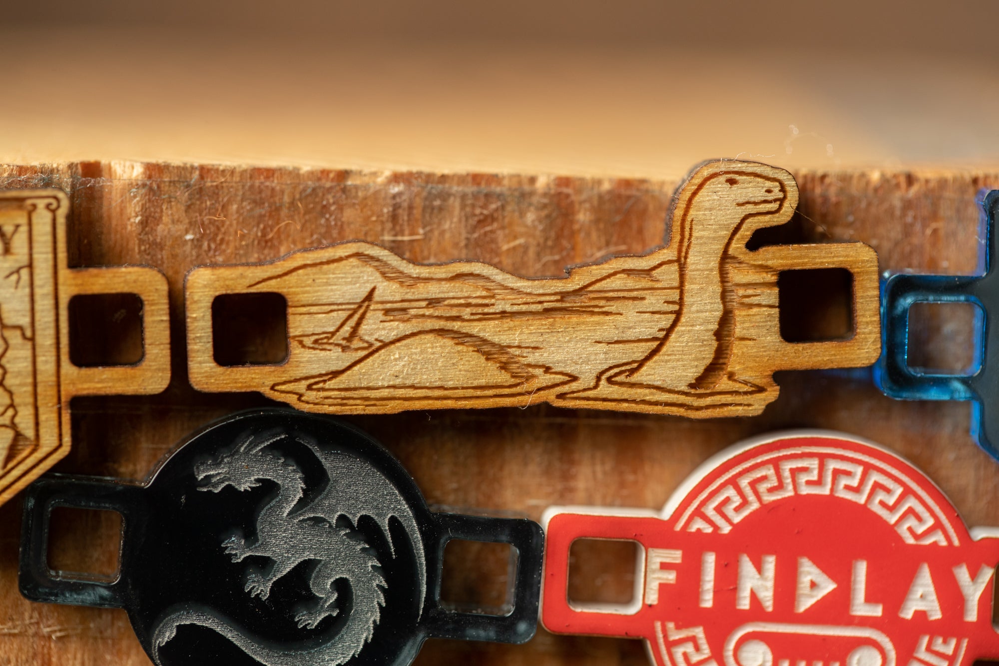 a wooden object with a dragon design, and there is a red object with the word "FINDlay" on it.