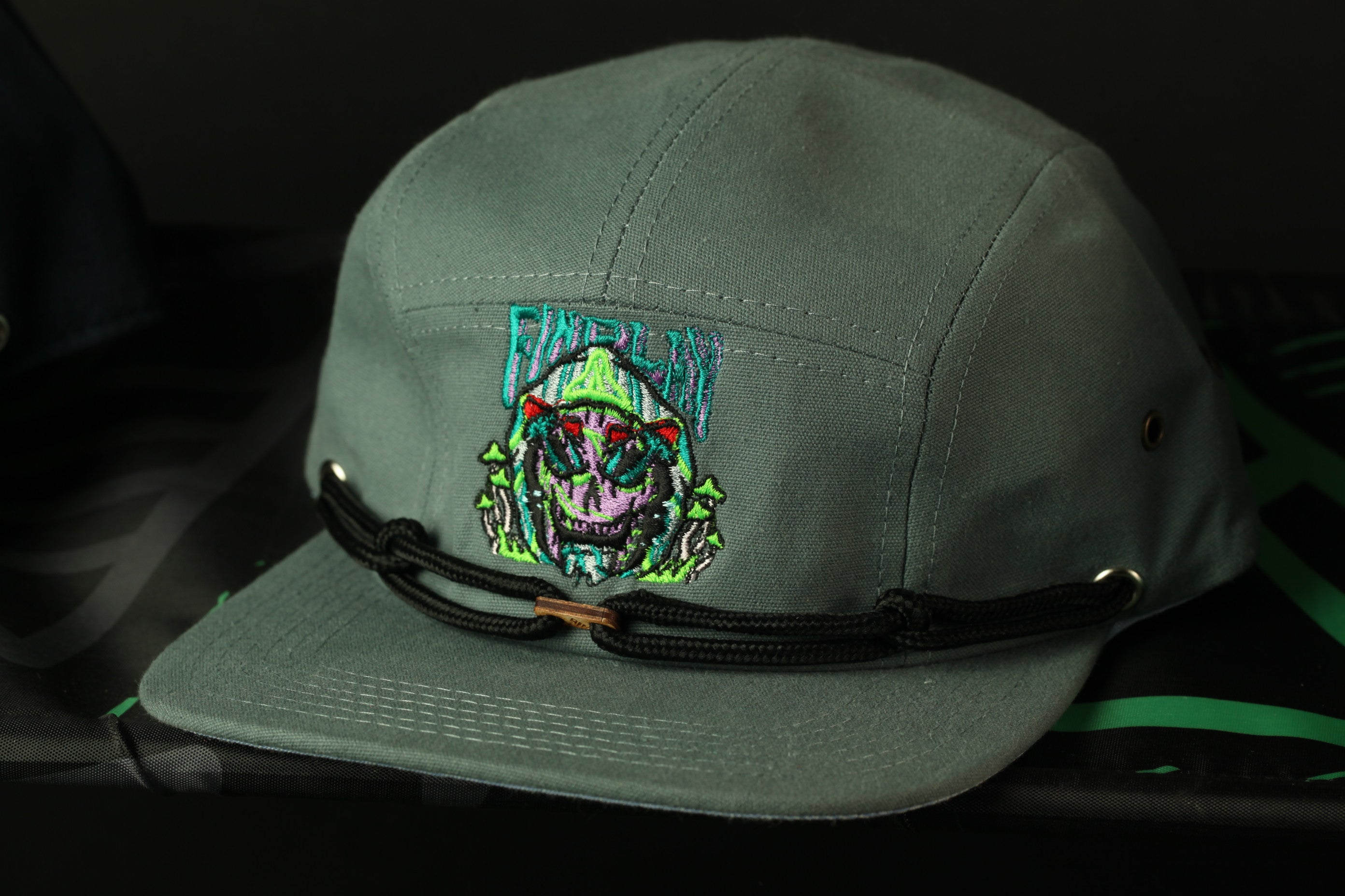 A gray baseball cap with a colorful graphic design on the front.