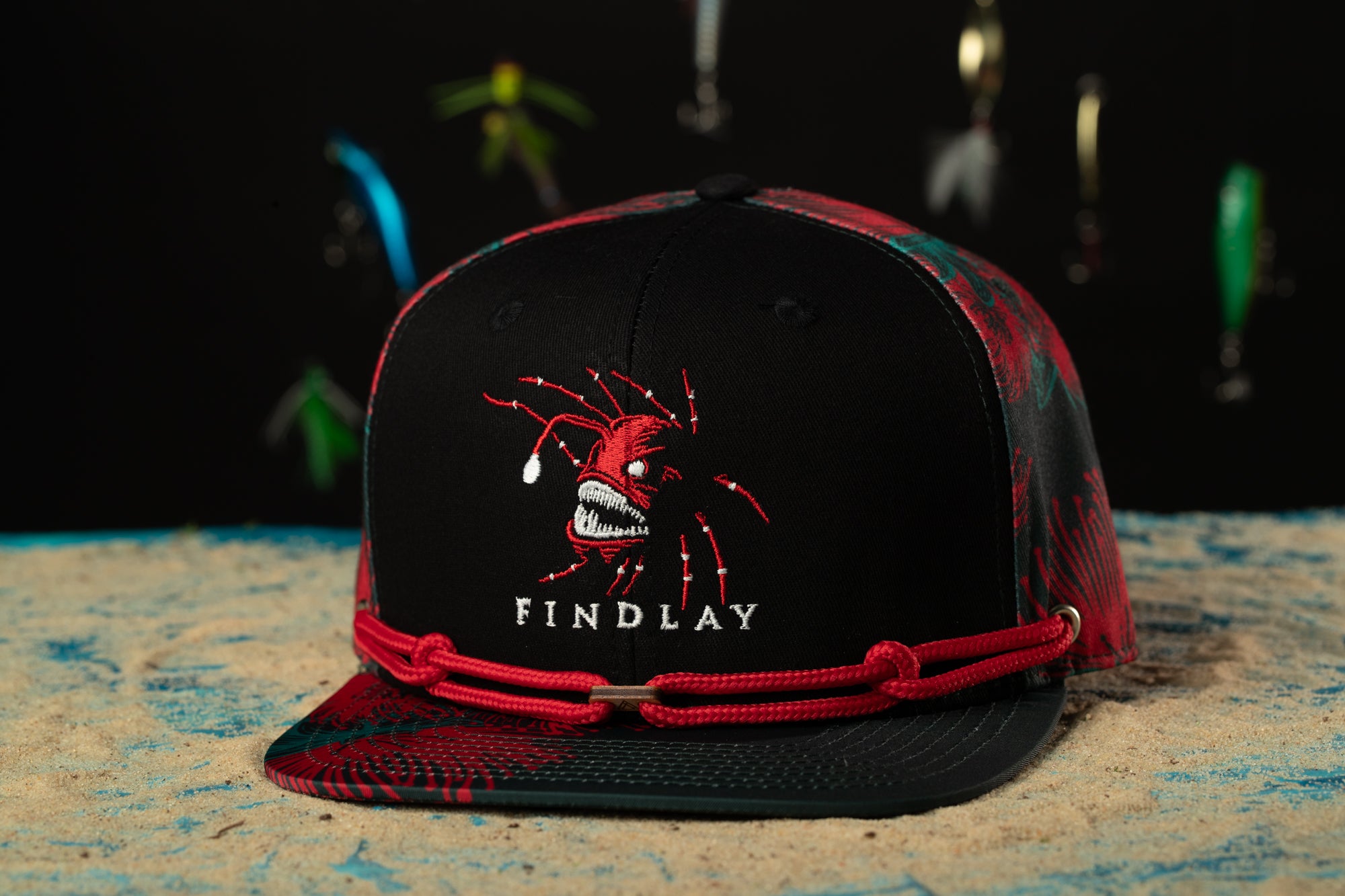 a black hat with a red band around the brim