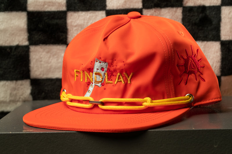 An orange baseball cap with a yellow chain strap and embroidered text on the front.