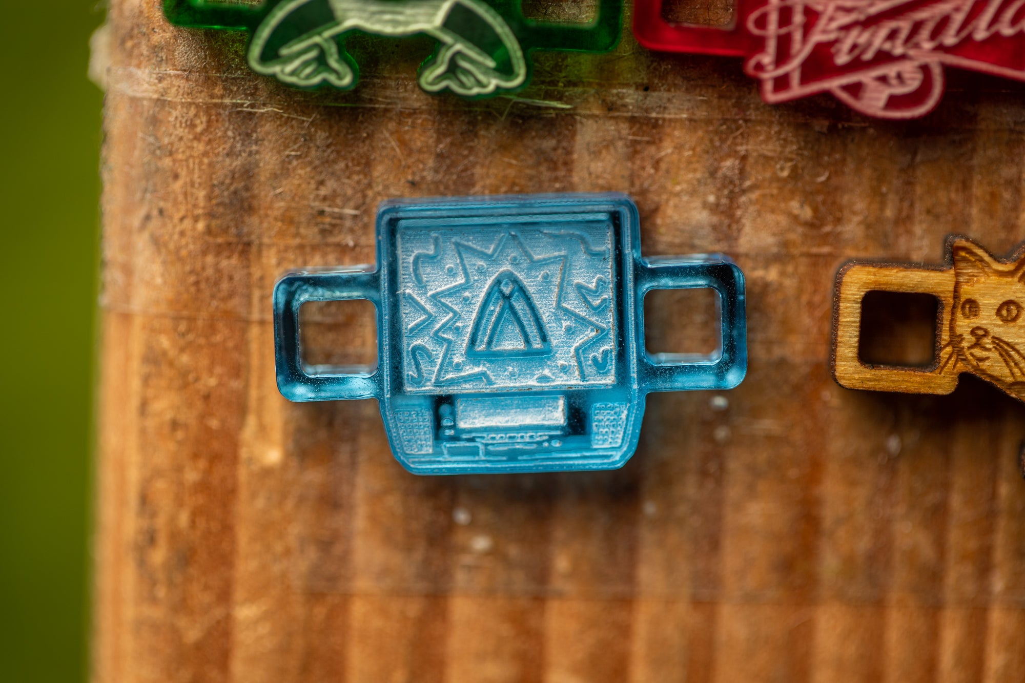 a blue object with a unique design, placed on a wooden surface.