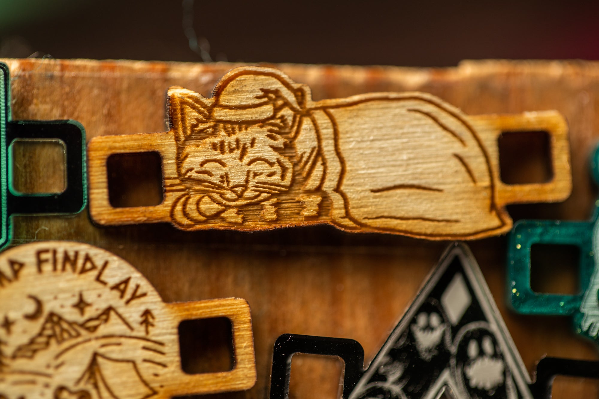 a wooden object with a carved design depicting a sleeping cat.